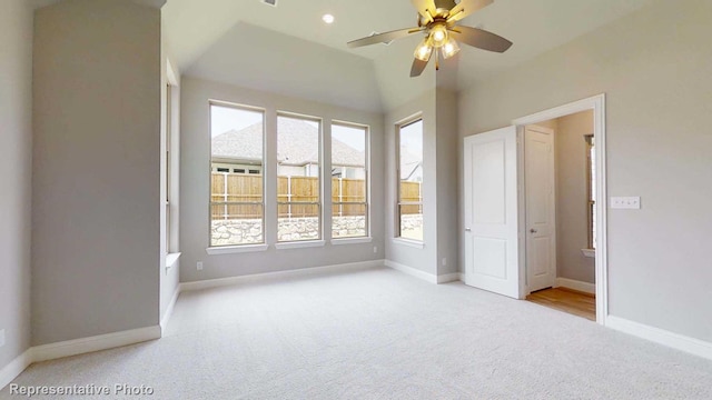 unfurnished bedroom with ensuite bath, light carpet, and multiple windows