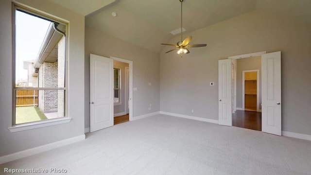 interior space featuring ceiling fan and high vaulted ceiling