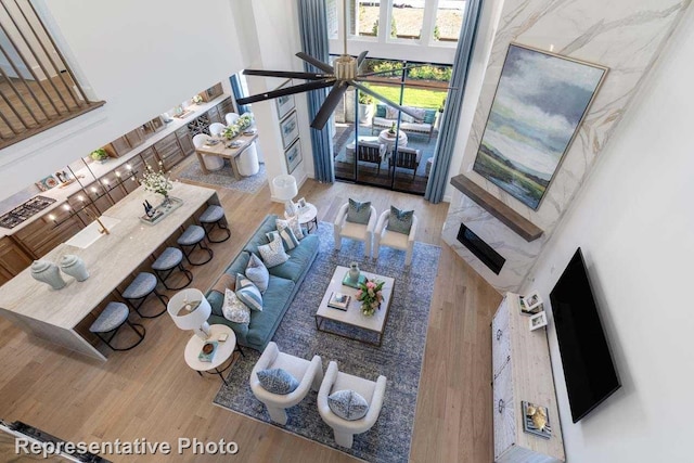 unfurnished living room with wood-type flooring and a high ceiling