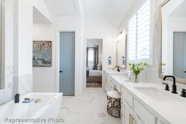 bathroom with a bath, vanity, a wealth of natural light, and lofted ceiling