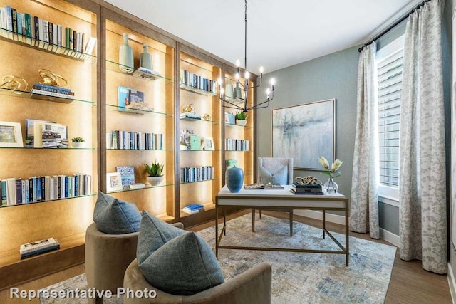 interior space with hardwood / wood-style floors, plenty of natural light, and an inviting chandelier