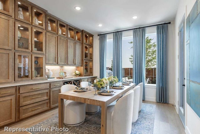 kitchen with tasteful backsplash and light hardwood / wood-style flooring