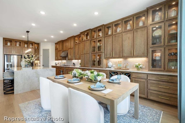 dining room featuring sink and light hardwood / wood-style flooring