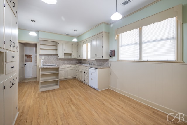 kitchen with white cabinetry, sink, white dishwasher, pendant lighting, and light hardwood / wood-style floors