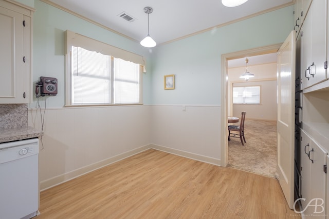 dining area with light hardwood / wood-style floors and crown molding