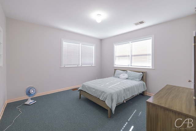 bedroom featuring dark carpet