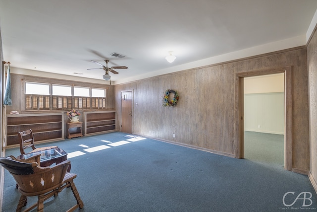 carpeted living room with ceiling fan