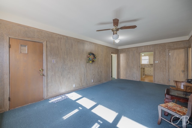 interior space featuring ceiling fan and carpet floors