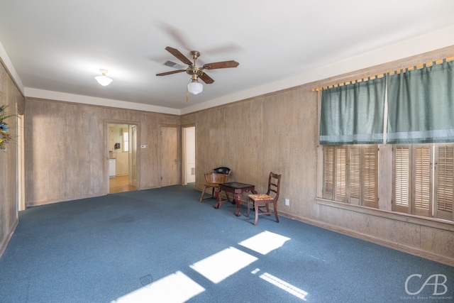 interior space featuring carpet and ceiling fan