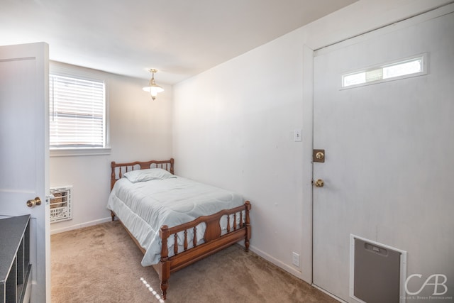 bedroom featuring a wall mounted air conditioner, light colored carpet, and heating unit