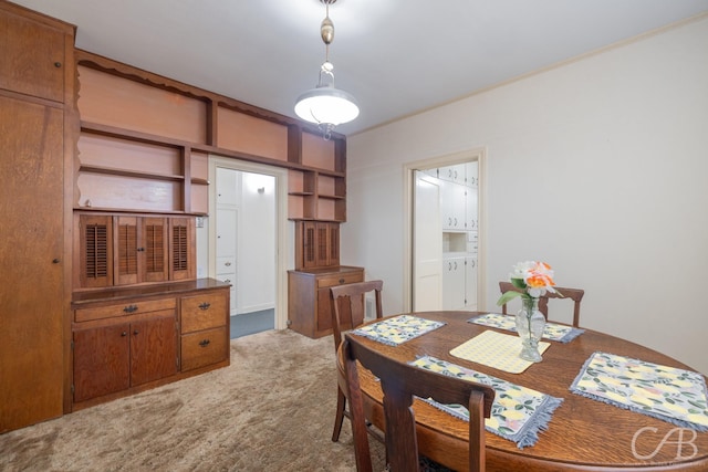 dining space with light colored carpet