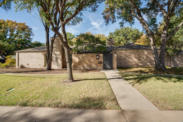 single story home featuring a front lawn