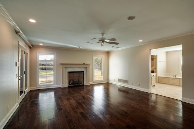 2516 Beefeater Dr, Wichita Falls, TX 76308 - unfurnished living room featuring wood finished floors, crown molding, recessed lighting, a ceiling fan, and a premium fireplace