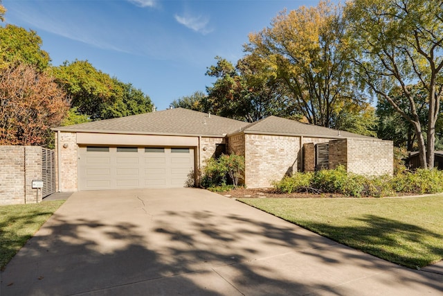 2516 Beefeater Dr, Wichita Falls, TX 76308 - view of front of house with driveway, brick siding, an attached garage, and a front lawn