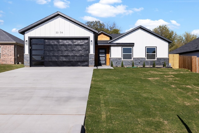 modern farmhouse with a front yard and a garage