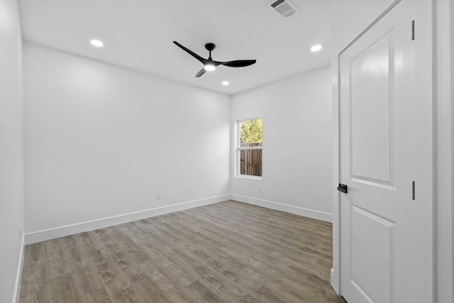 empty room with light wood-type flooring and ceiling fan