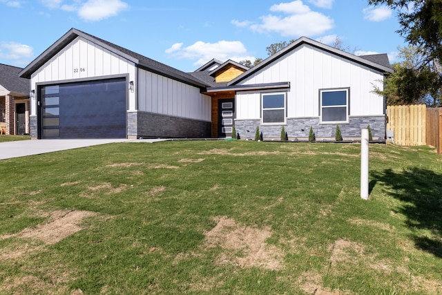 modern farmhouse featuring a garage and a front lawn