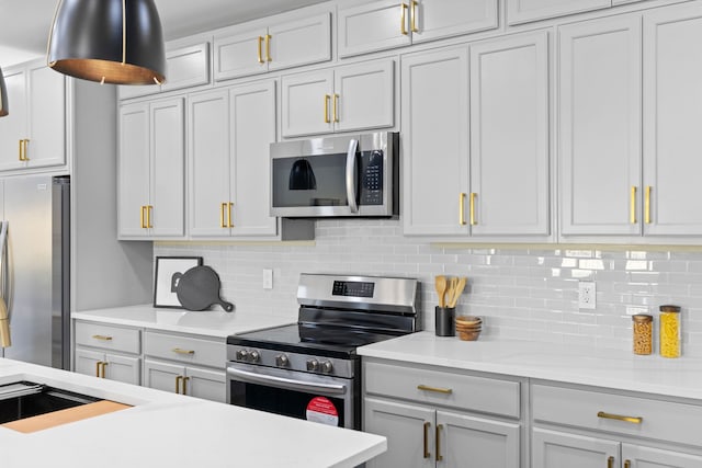 kitchen with tasteful backsplash and appliances with stainless steel finishes