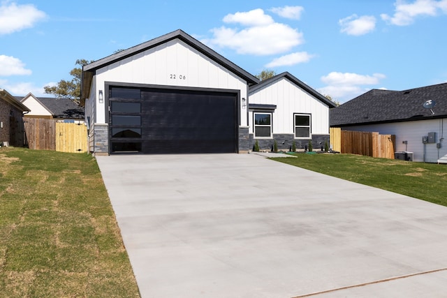 modern inspired farmhouse featuring central AC unit, a garage, and a front lawn