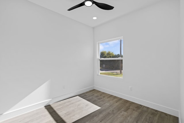 empty room with ceiling fan and hardwood / wood-style flooring