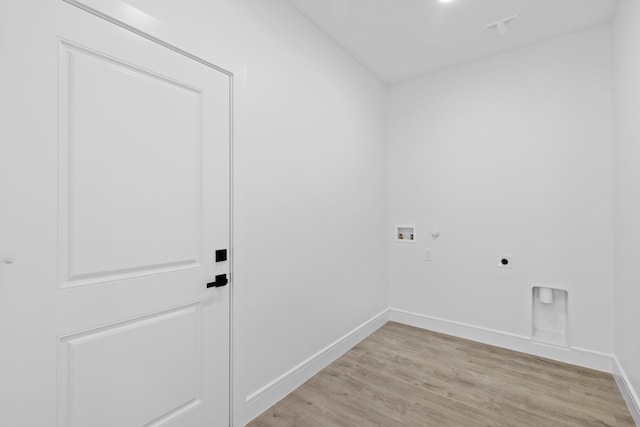 washroom featuring hookup for a washing machine, light wood-type flooring, and hookup for an electric dryer