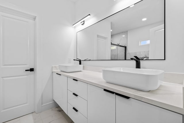 bathroom with vanity and a shower with shower door