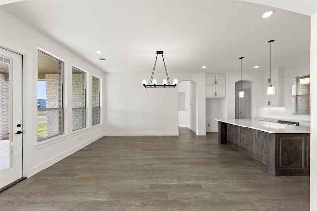 kitchen featuring decorative light fixtures, dark hardwood / wood-style floors, and white cabinetry