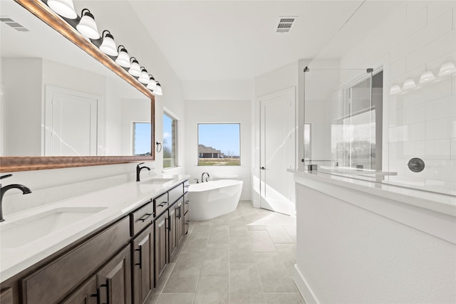 bathroom with tile patterned flooring, vanity, and separate shower and tub