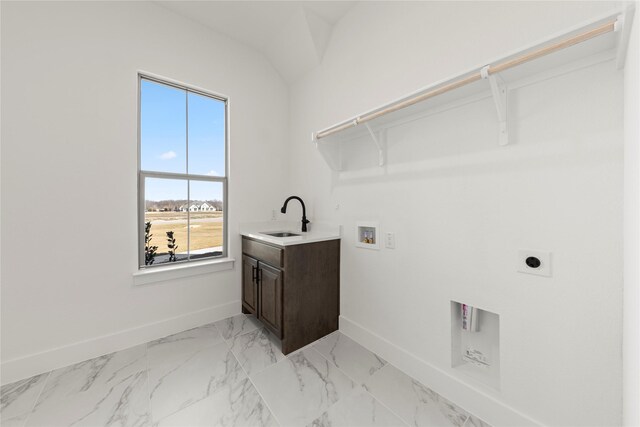 clothes washing area with hookup for a washing machine, sink, cabinets, and hookup for an electric dryer