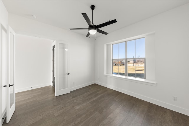 unfurnished room with ceiling fan and dark hardwood / wood-style floors