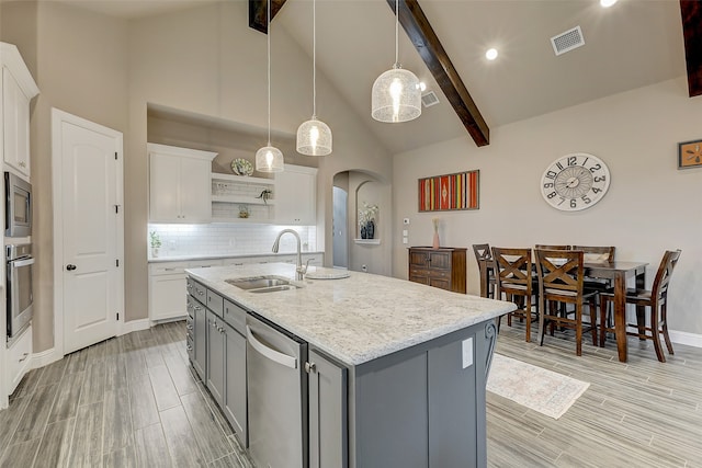 kitchen with gray cabinetry, white cabinets, sink, hanging light fixtures, and stainless steel appliances