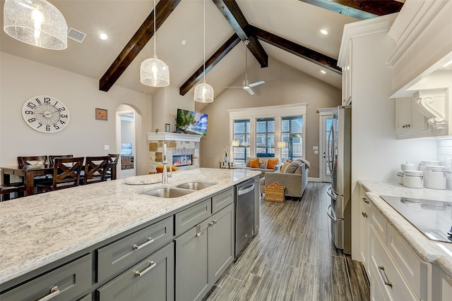 kitchen featuring appliances with stainless steel finishes, dark hardwood / wood-style flooring, sink, gray cabinets, and white cabinetry