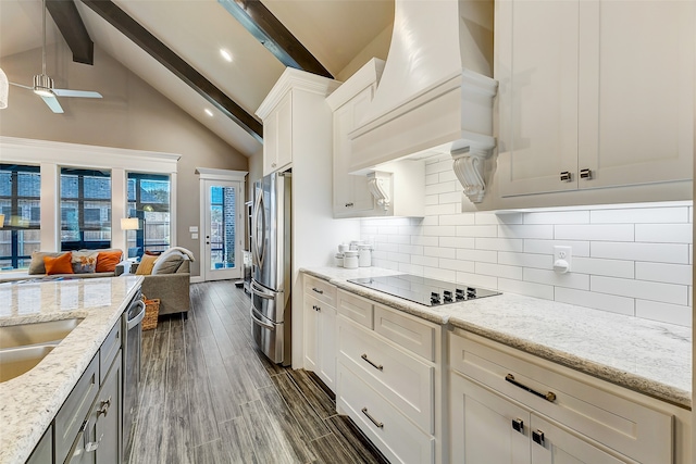 kitchen featuring dark hardwood / wood-style floors, beam ceiling, premium range hood, and appliances with stainless steel finishes