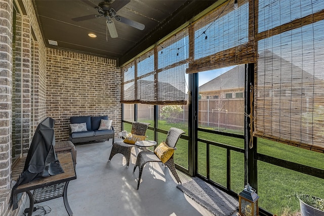 sunroom / solarium with a wealth of natural light and ceiling fan