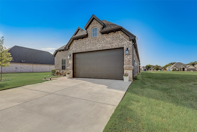 french provincial home with a front yard and a garage