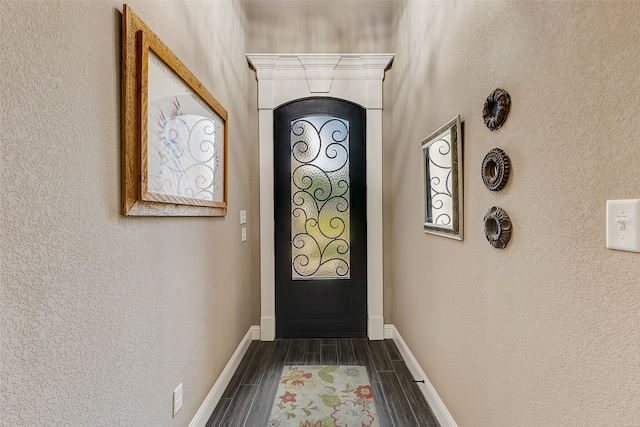 doorway to outside with dark wood-type flooring