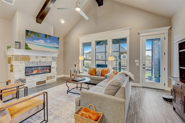 living room with high vaulted ceiling, light hardwood / wood-style flooring, ceiling fan, a fireplace, and beam ceiling