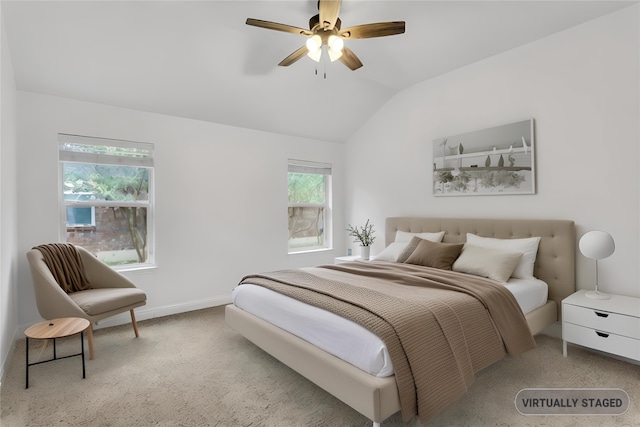 carpeted bedroom with ceiling fan and lofted ceiling