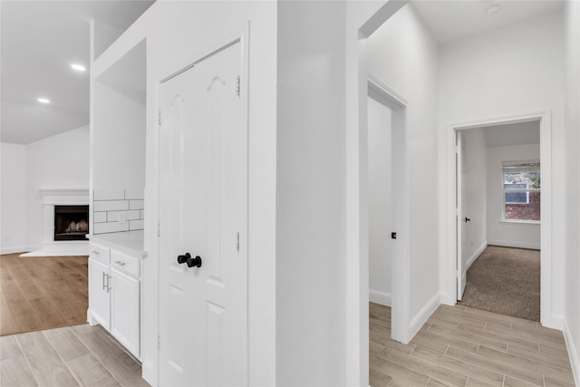 hallway with light hardwood / wood-style floors