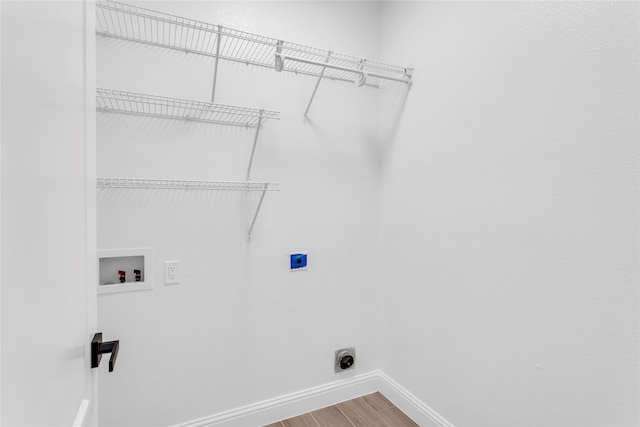 laundry room featuring washer hookup, hardwood / wood-style flooring, and electric dryer hookup