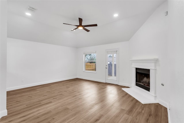 unfurnished living room featuring ceiling fan, light hardwood / wood-style flooring, and lofted ceiling