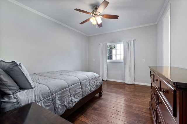 bedroom with dark hardwood / wood-style floors, ceiling fan, and crown molding