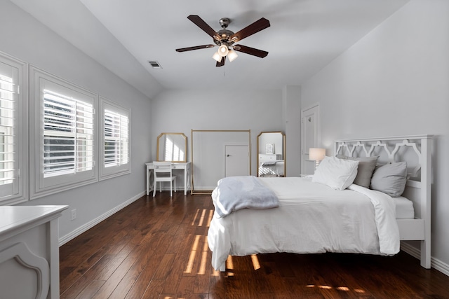 bedroom with dark hardwood / wood-style flooring and ceiling fan