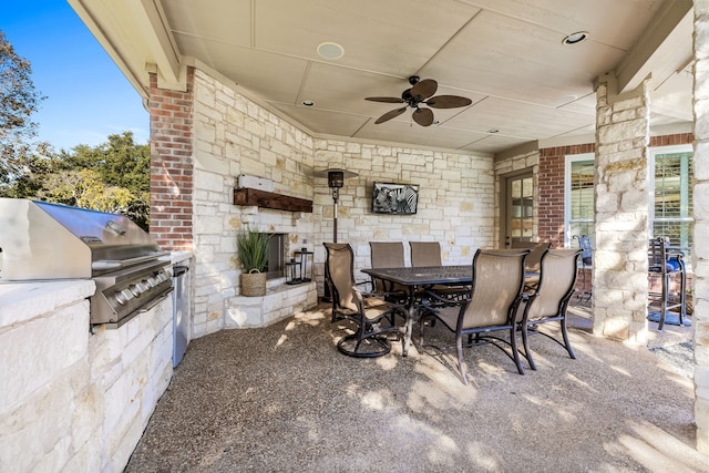 view of patio / terrace featuring a grill, ceiling fan, and exterior kitchen