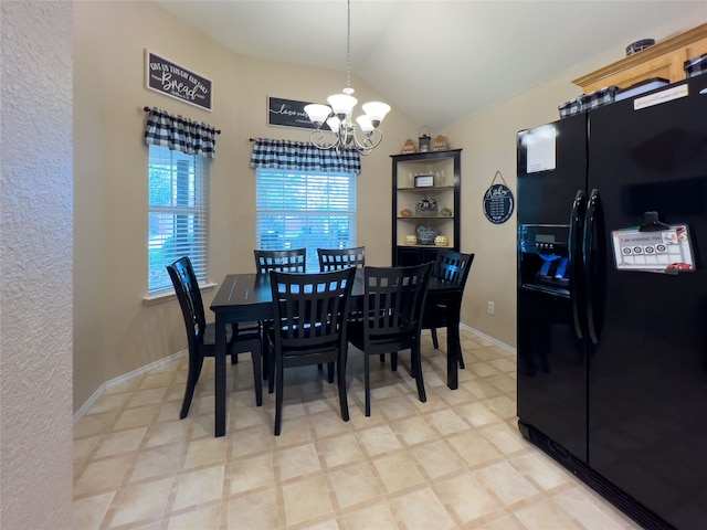 dining area with a chandelier and lofted ceiling