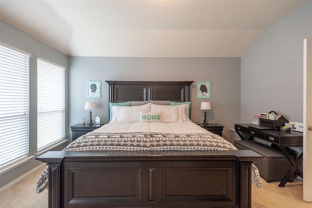 carpeted bedroom with lofted ceiling