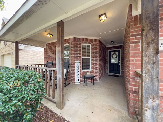 view of exterior entry featuring a porch