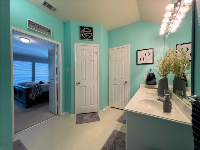 bathroom featuring vanity and vaulted ceiling