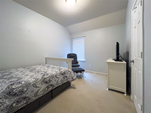 carpeted bedroom featuring lofted ceiling