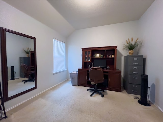 home office featuring light colored carpet and lofted ceiling